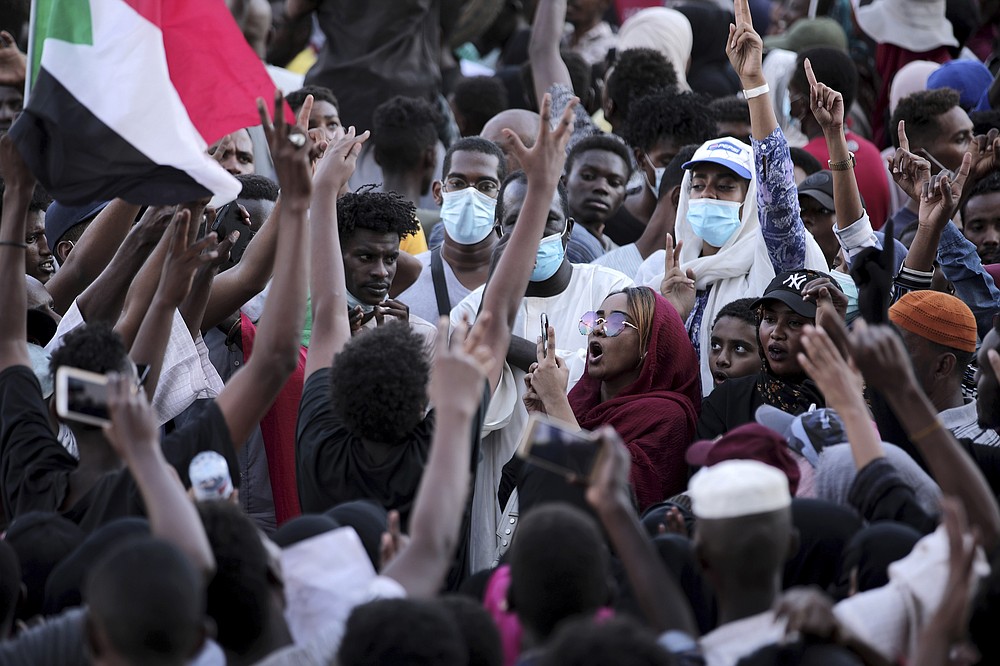People chant slogans during a protest in Khartoum, Sudan, Saturday, Oct. 30, 2021. Pro-democracy groups called for mass protest marches across the country Saturday to press demands for re-instating a deposed transitional government and releasing senior political figures from detention. (AP Photo/Marwan Ali)