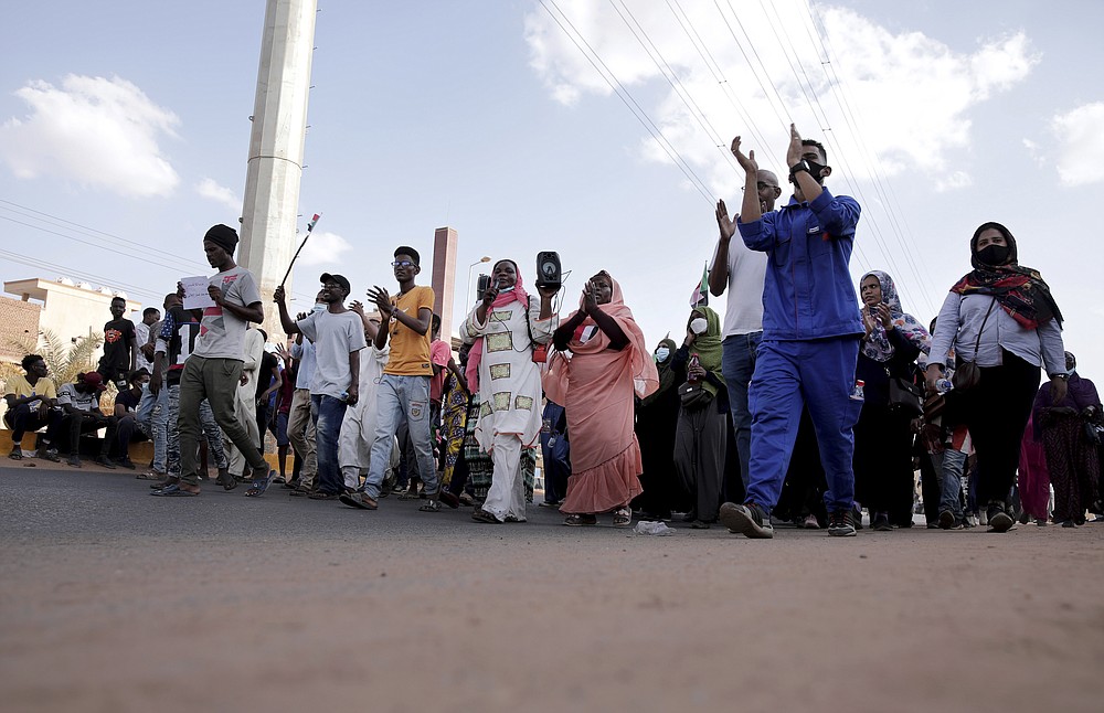 People chant slogans during a protest in Khartoum, Sudan, Saturday, Oct. 30, 2021. Pro-democracy groups called for mass protest marches across the country Saturday to press demands for re-instating a deposed transitional government and releasing senior political figures from detention. (AP Photo/Marwan Ali)