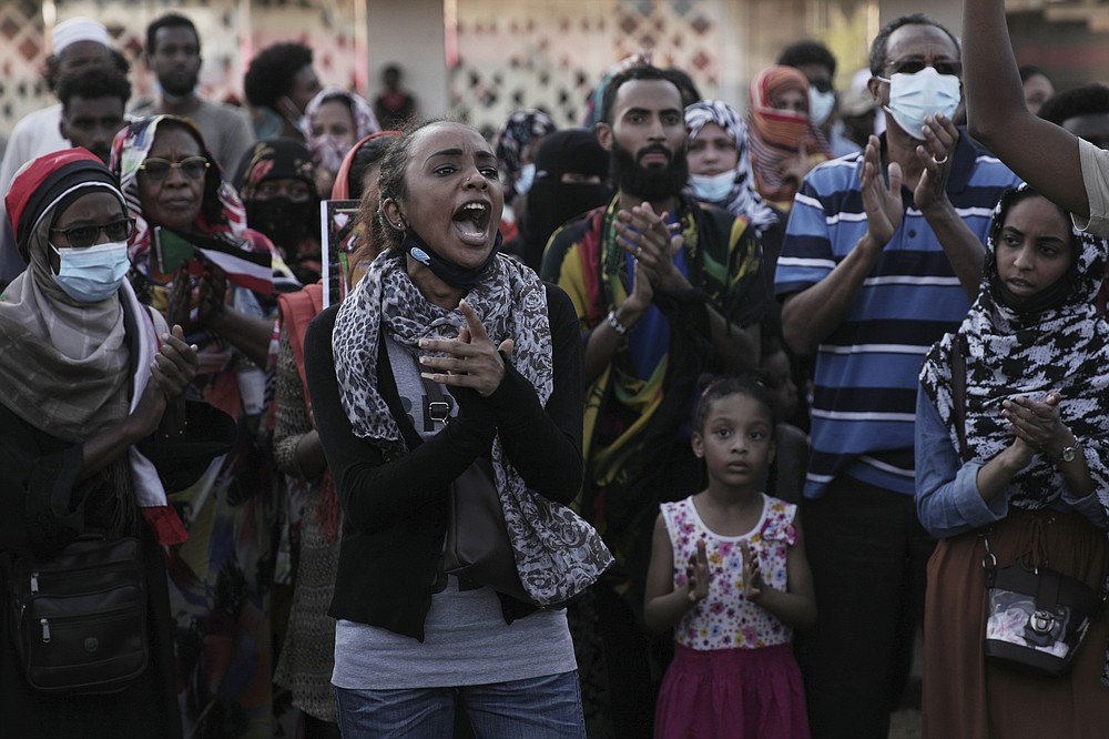 People chant slogans during a protest in Khartoum, Sudan, Saturday, Oct. 30, 2021. Pro-democracy groups called for mass protest marches across the country Saturday to press demands for re-instating a deposed transitional government and releasing senior political figures from detention. (AP Photo/Marwan Ali)