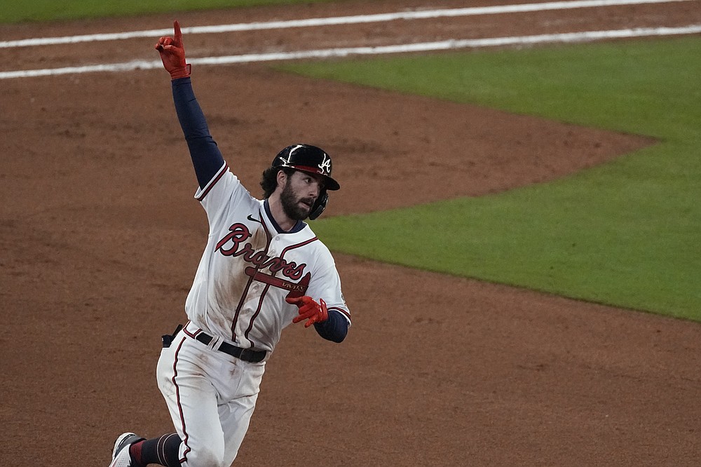 Atlanta Braves' Dansby Swanson celebrates his home run during the seventh inning in Game 4 of baseball's World Series between the Houston Astros and the Atlanta Braves Saturday, Oct. 30, 2021, in Atlanta. (AP Photo/John Bazemore)