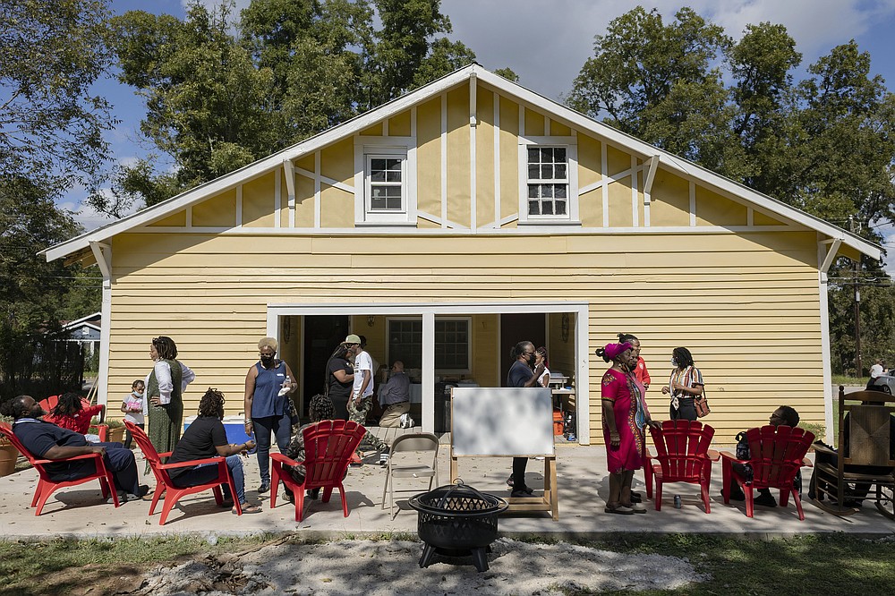 Visitors gather for storytelling, drumming, music and food at the Greene County African American Museum during its grand-opening in Greene County, Ga., on Oct. 16. (Athens Banner-Herald/Kayla Renie via AP)