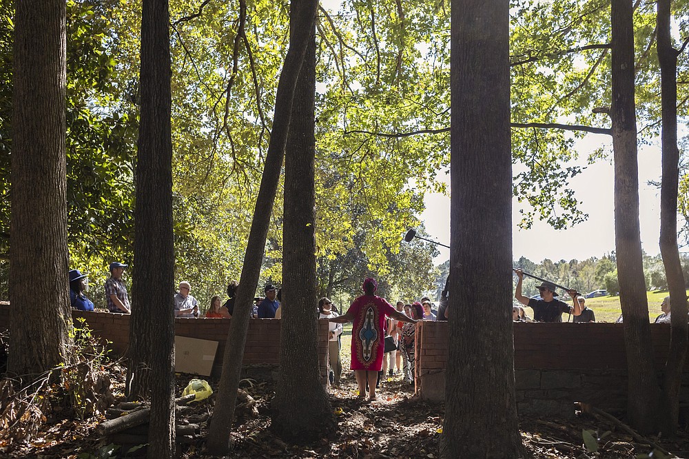 Mamie Hillman stands at the opening of the wall that once divided where Black and white people were buried at the Penfield African American Cemetery in Greene County, Ga., on Oct. 16. (Athens Banner-Herald/Kayla Renie via AP)