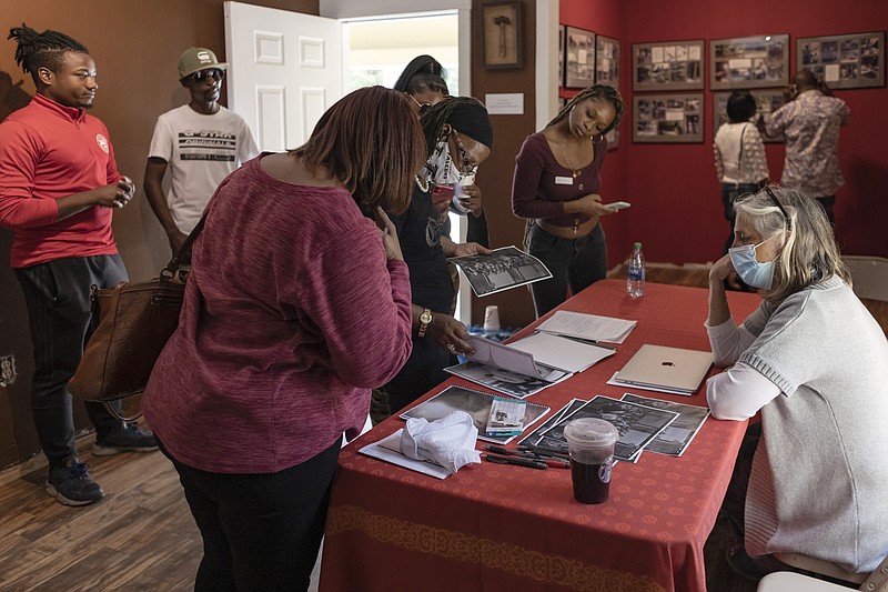 Visitors explore the exhibits and artifacts on display at the Greene County African American Museum during its grand opening in Greene County, Ga., on Oct. 16. After more than 20 years of planning, Mamie Hillman completed a lifelong passion and opened a Black museum in Greene County. (AP/Athens Banner-Herald/Kayla Renie)