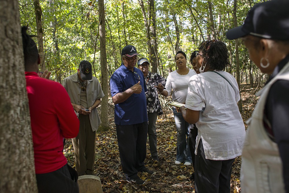James McWhorter (center), along with friends and family, pays his respects to his ancestors buried at the Penfield African American Cemetery in Greene County, Ga., on Oct. 16. (Athens Banner-Herald/Kayla Renie via AP)