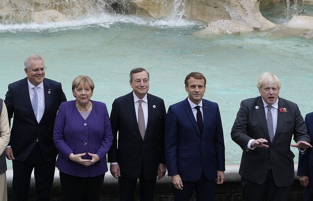 From left, Australia's Prime Minister Scott Morrison, German Chancellor Angela Merkel, Italy's Prime Minister Mario Draghi, French President Emmanuel Macron and British Prime Minister Boris Johnson pose in front of the Trevi Fountain during an event for the G20 summit in Rome, Sunday, Oct. 31, 2021. The two-day Group of 20 summit concludes on Sunday, the first in-person gathering of leaders of the world's biggest economies since the COVID-19 pandemic started. (AP Photo/Gregorio Borgia)
