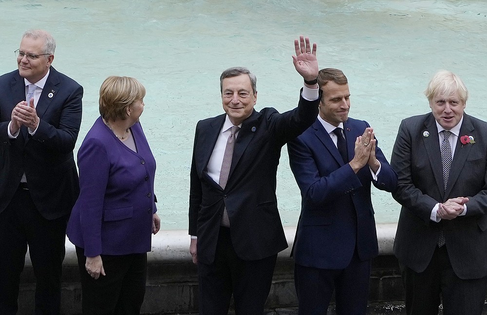 From left, Australia's Prime Minister Scott Morrison, German Chancellor Angela Merkel, Italy's Prime Minister Mario Draghi, French President Emmanuel Macron and British Prime Minister Boris Johnson pose in front of the Trevi Fountain during an event for the G20 summit in Rome, Sunday, Oct. 31, 2021. The two-day Group of 20 summit concludes on Sunday, the first in-person gathering of leaders of the world's biggest economies since the COVID-19 pandemic started. (AP Photo/Gregorio Borgia)