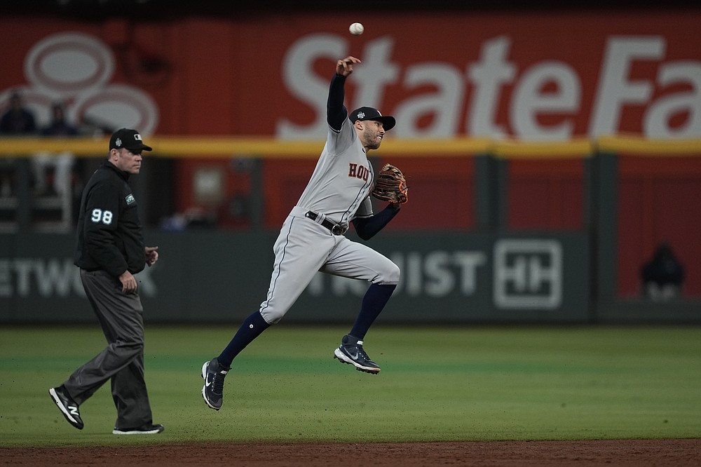 Houston Astros shortstop Carlos Correa throws Atlanta Braves' Dansby Swanson out at first during the second inning in Game 5 of baseball's World Series between the Houston Astros and the Atlanta Braves Sunday, Oct. 31, 2021, in Atlanta. (AP Photo/David J. Phillip)