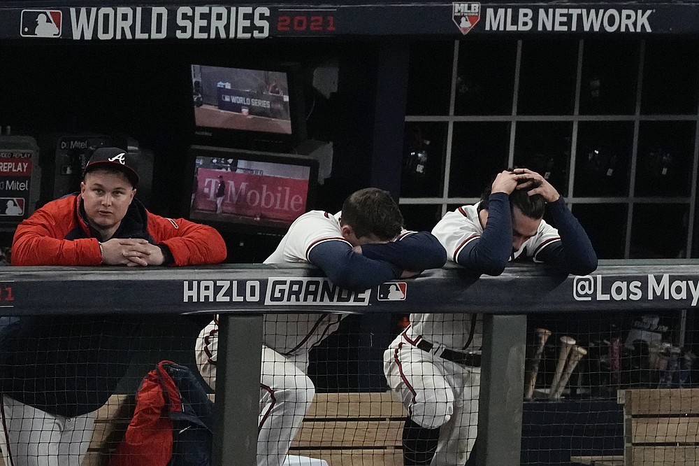 Atlanta Braves right fielder Joc Pederson, from left, third baseman Austin Riley and shortstop Dansby Swanson react during the ninth inning in Game 5 of baseball's World Series between the Houston Astros and the Atlanta Braves Monday, Nov. 1, 2021, in Atlanta. (AP Photo/John Bazemore)