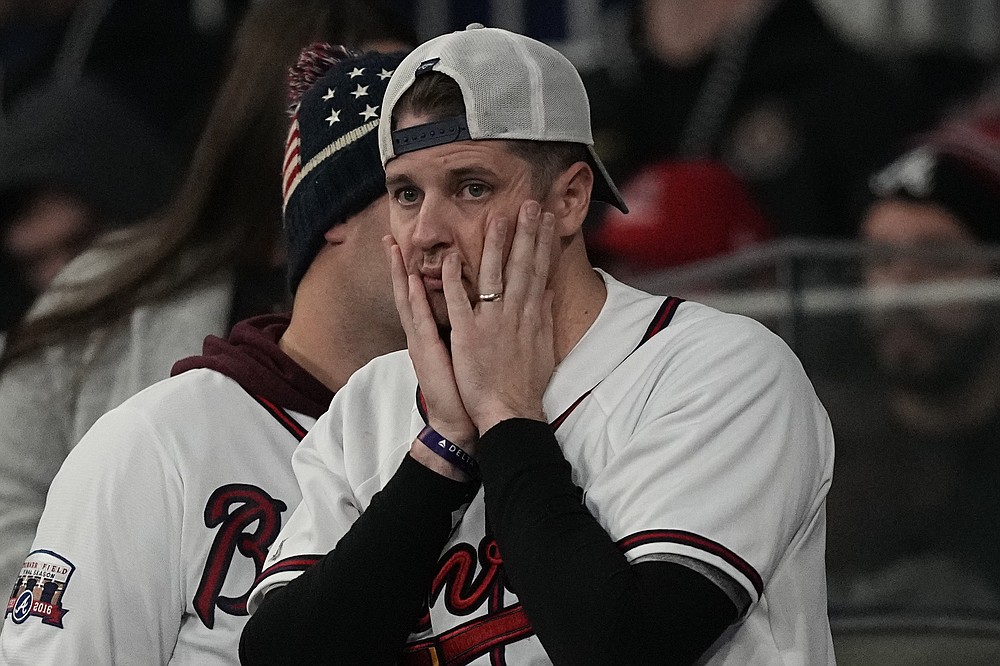 A Atlanta Braves fan watches during the ninth inning in Game 5 of baseball's World Series between the Houston Astros and the Atlanta Braves Monday, Nov. 1, 2021, in Atlanta. (AP Photo/David J. Phillip)
