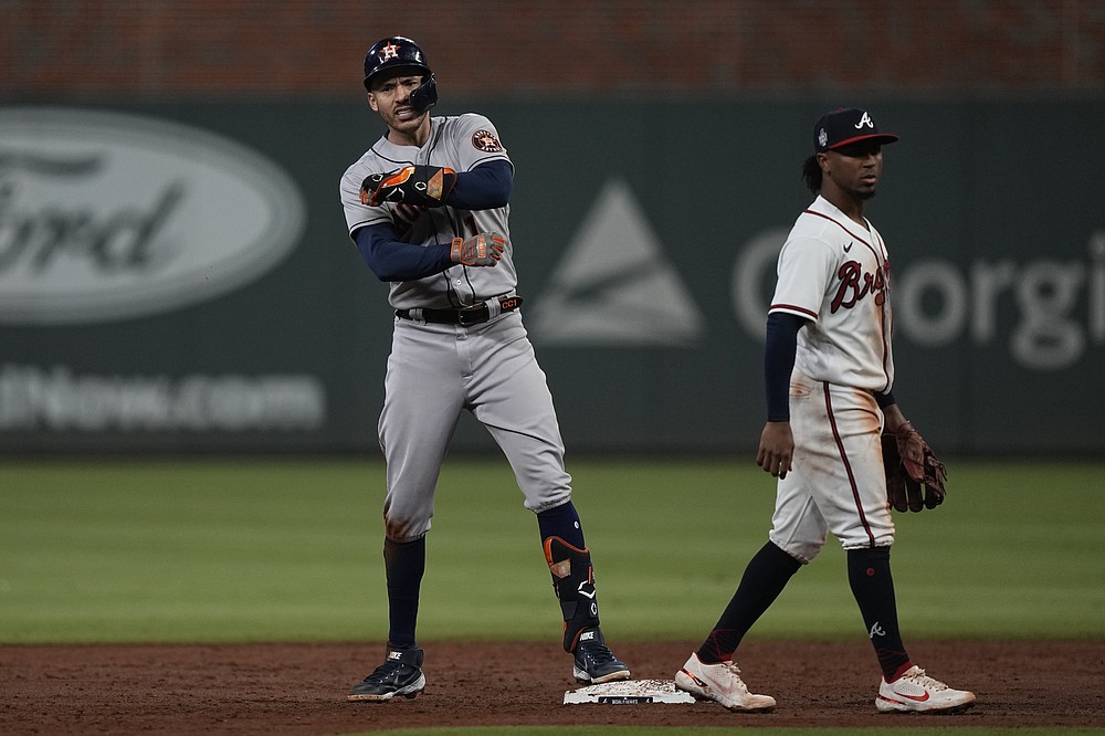 Houston Astros' Carlos Correa celebrates after an RBI-double during the third inning in Game 5 of baseball's World Series between the Houston Astros and the Atlanta Braves Sunday, Oct. 31, 2021, in Atlanta. (AP Photo/David J. Phillip)