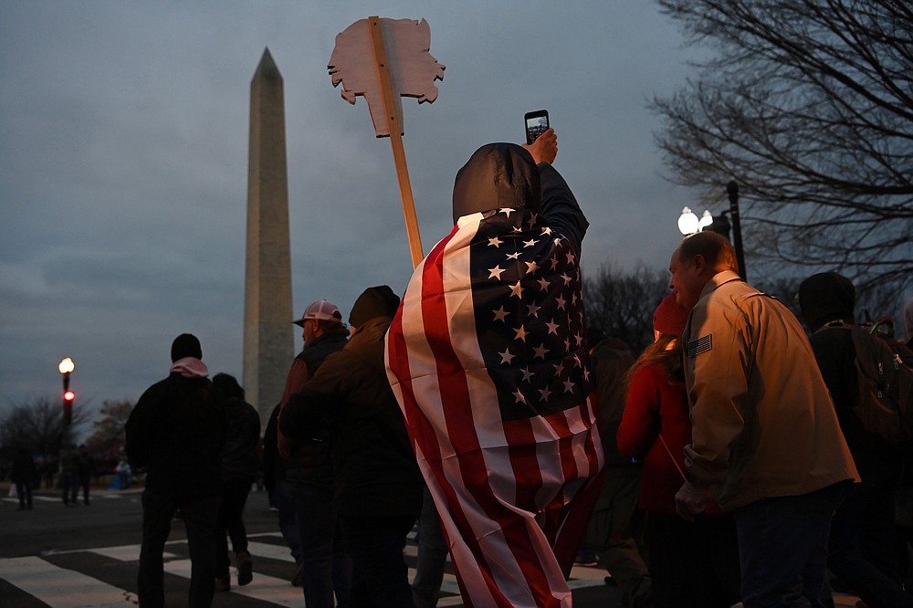 Supporters of President Donald Trump wend through Washington early on Jan. 6., 2021 in Washington. MUST CREDIT: Washington Post photo by Matt McClain
