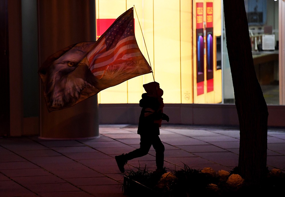 A child with a flag walks with supporters of President Donald Trump walk towards the Save America March event near the White House on Jan. 6, 2021 in Washington,. MUST CREDIT: Washington Post photo by Matt McClain