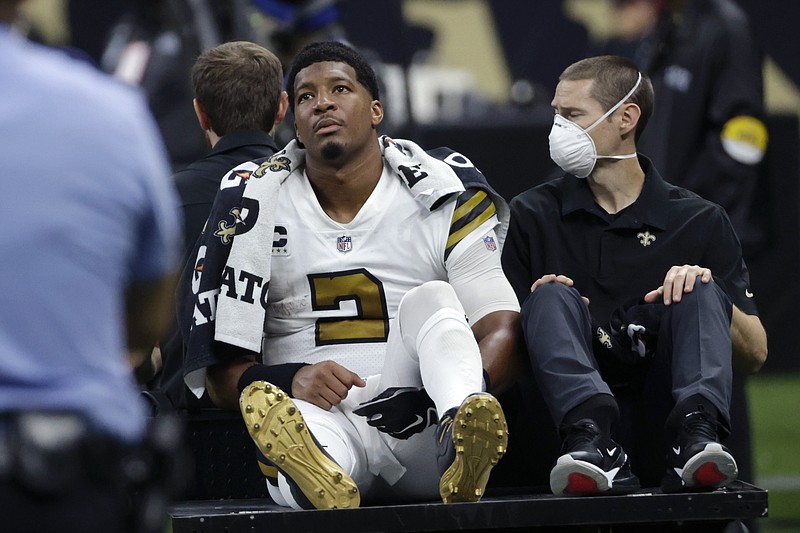 New Orleans Saints quarterback Jameis Winston (2) is carted off the field after being injured from a horse collar tackle in the first half of an NFL football game against the Tampa Bay Buccaneers in New Orleans, Sunday, Oct. 31, 2021. (AP Photo/Derick Hingle)