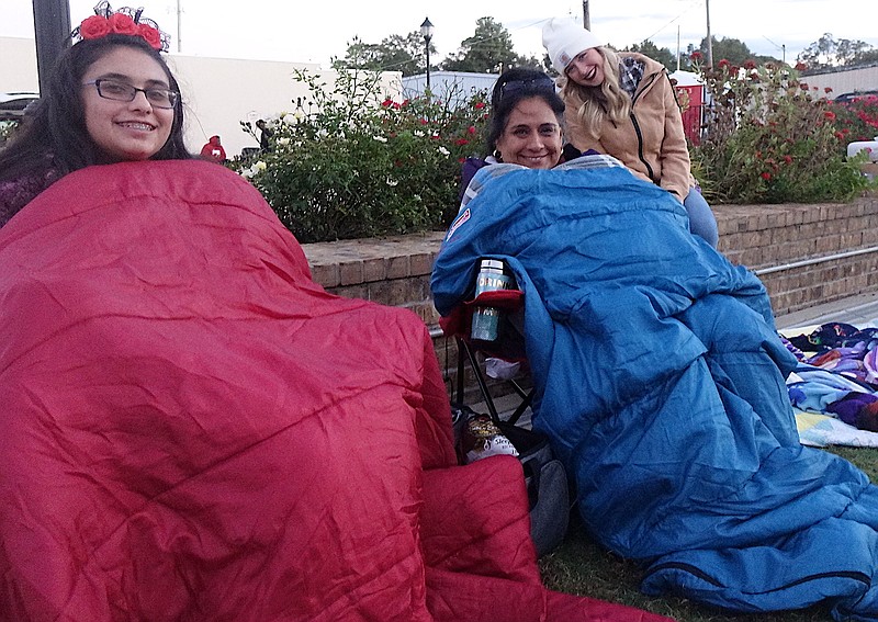 It is, indeed, autumn in Northeast Texas — time for the blankets being put to good use by, from left, Vanessa Winders and Yolanda Winders. That’s Sara Heath smiling in the background.