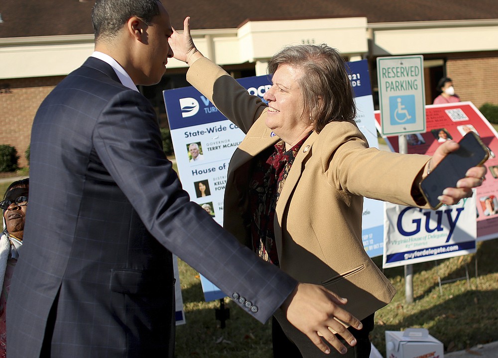 Virginia House of Delegates District 83 incumbent Nancy Guy, a Democrat, gets a hug of support from fellow delegate Jay Jones at the Ebenezer Baptist Church polling place early Tuesday, Nov. 2, 2021, in Virginia Beach, Va. (Stephen M. Katz/The Virginian-Pilot via AP)