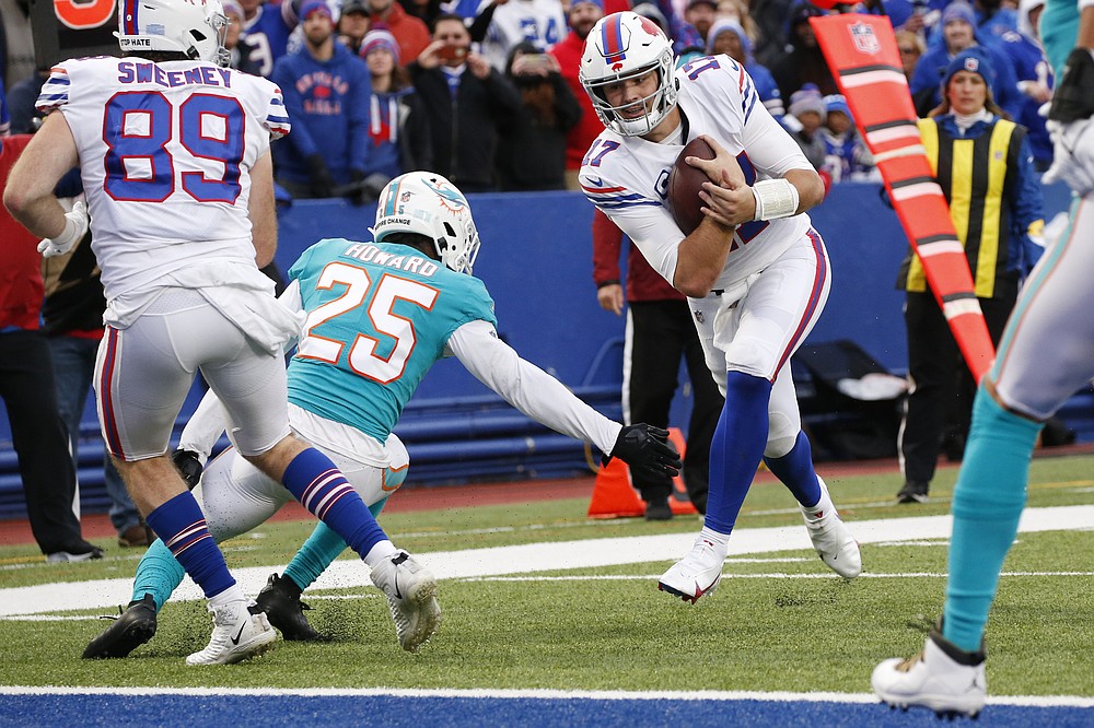 Buffalo Bills quarterback Josh Allen (17) hangs onto the ball as he passes Miami Dolphins cornerback Xavien Howard (25) on his touchdown during the second half of an NFL football game, Sunday, Oct. 31, 2021, in Orchard Park, N.Y. (AP Photo/Jeffrey T. Barnes)