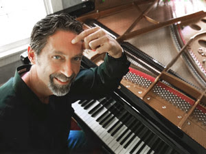 Pianist Scott Kirby performs Scott Joplin's music by the downtown mural on Saturday - Vimarsana News