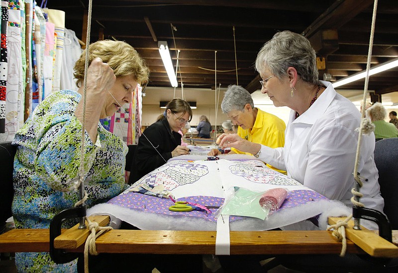 NWA Democrat-Gazette/DAVID GOTTSCHALK - 5/19/15 - Sondra Thomas (left to right), Desire&#x201a;&#xc4;&#xf4; Gashler, Sharon Morgan and Eloise Gusman, quilters and members of the Rural Builders Club, an all-female group, work on baby quilts in the basement of Son's Chapel in Fayetteville before a soup lunch is served Tuesday May 19, 2015. A 75th anniversary of the dedication of the chapel with an open house is planned for May 30.