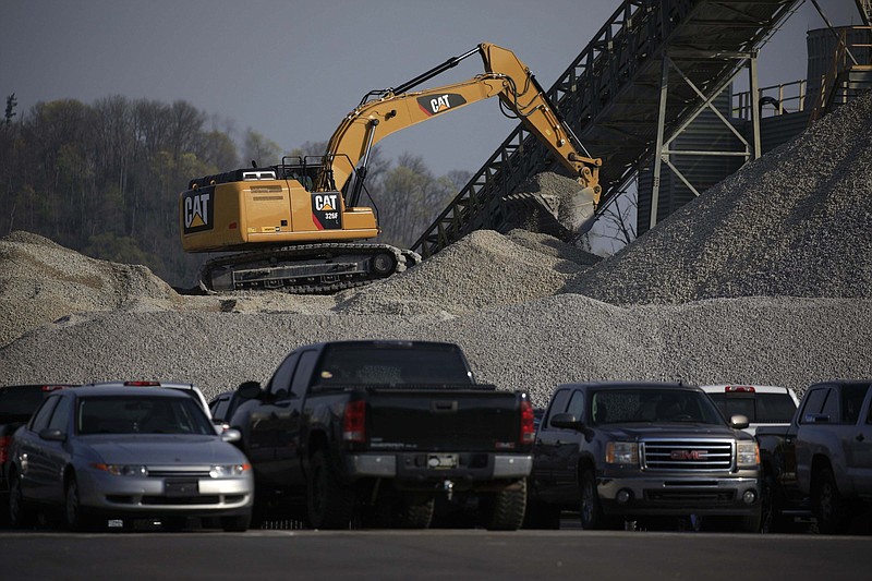 A Caterpillar excavator operates at the Kentucky Utilities Co. Ghent generating station in Ghent, Ky., on April 6, 2021. MUST CREDIT: Bloomberg photo by Luke Sharrett.