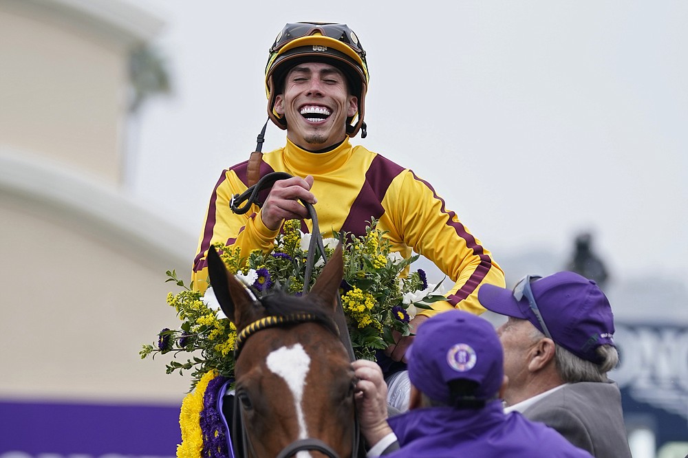 Irad Ortiz Jr. celebrates atop Twilight Gleaming after winning the Breeders' Cup Juvenile Turf Sprint race at the Del Mar racetrack in Del Mar, Calif., Friday, Nov. 5, 2021. (AP Photo/Jae C. Hong)