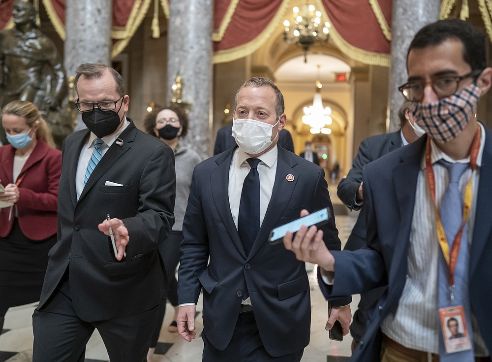 Reporters try to get an update from Rep. Josh Gottheimer, D-N.J., center, about his concerns as the House considers President Joe Biden's $1.85 trillion-and-growing domestic policy package, at the Capitol in Washington, Friday, Nov. 5, 2021. The hard-fought social policy and climate-change legislation will still have to clear the 50-50-Senate, where revisions are likely and Biden has no votes to spare. (AP Photo/J. Scott Applewhite)