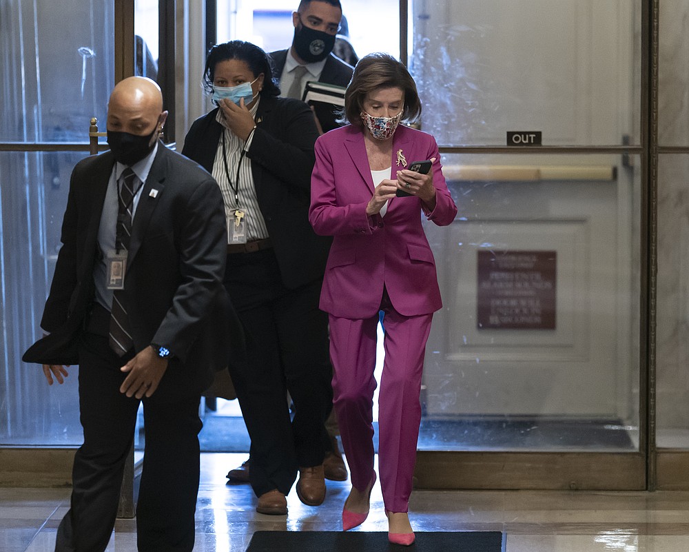 Speaker of the House Nancy Pelosi, D-Calif., arrives to lead Democrats in advancing President Joe Biden's $1.85 trillion-and-growing domestic policy package, at the Capitol in Washington, Friday, Nov. 5, 2021. The hard-fought social policy and climate-change legislation will still have to clear the 50-50-Senate, where revisions are likely and Biden has no votes to spare. (AP Photo/J. Scott Applewhite)
