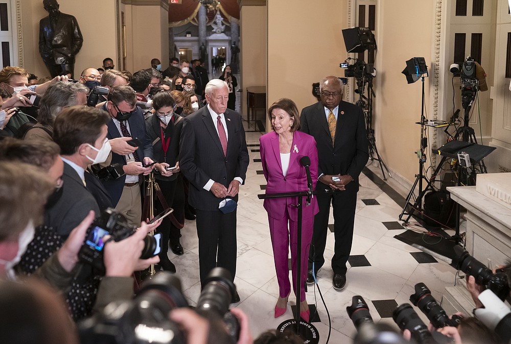 Speaker of the House Nancy Pelosi, D-Calif., center, flanked by House Majority Leader Steny Hoyer, D-Md., left, and House Majority Whip James Clyburn, D-S.C., speaks after a day of delays in the vote to advance President Joe Biden's domestic policy package, at the Capitol in Washington, Friday, Nov. 5, 2021. (AP Photo/J. Scott Applewhite)