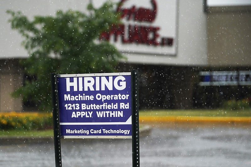 FILE - A hiring sign is displayed in Downers Grove, Ill., on June 24, 2021.  The number of Americans applying for unemployment benefits fell to a fresh pandemic low last week, Thursday, Nov. 4, another sign the job market is healing after last year&#x2019;s coronavirus recession. Jobless claims dropped by 14,000 to 269,000 last week.  (AP Photo/Nam Y. Huh, File)