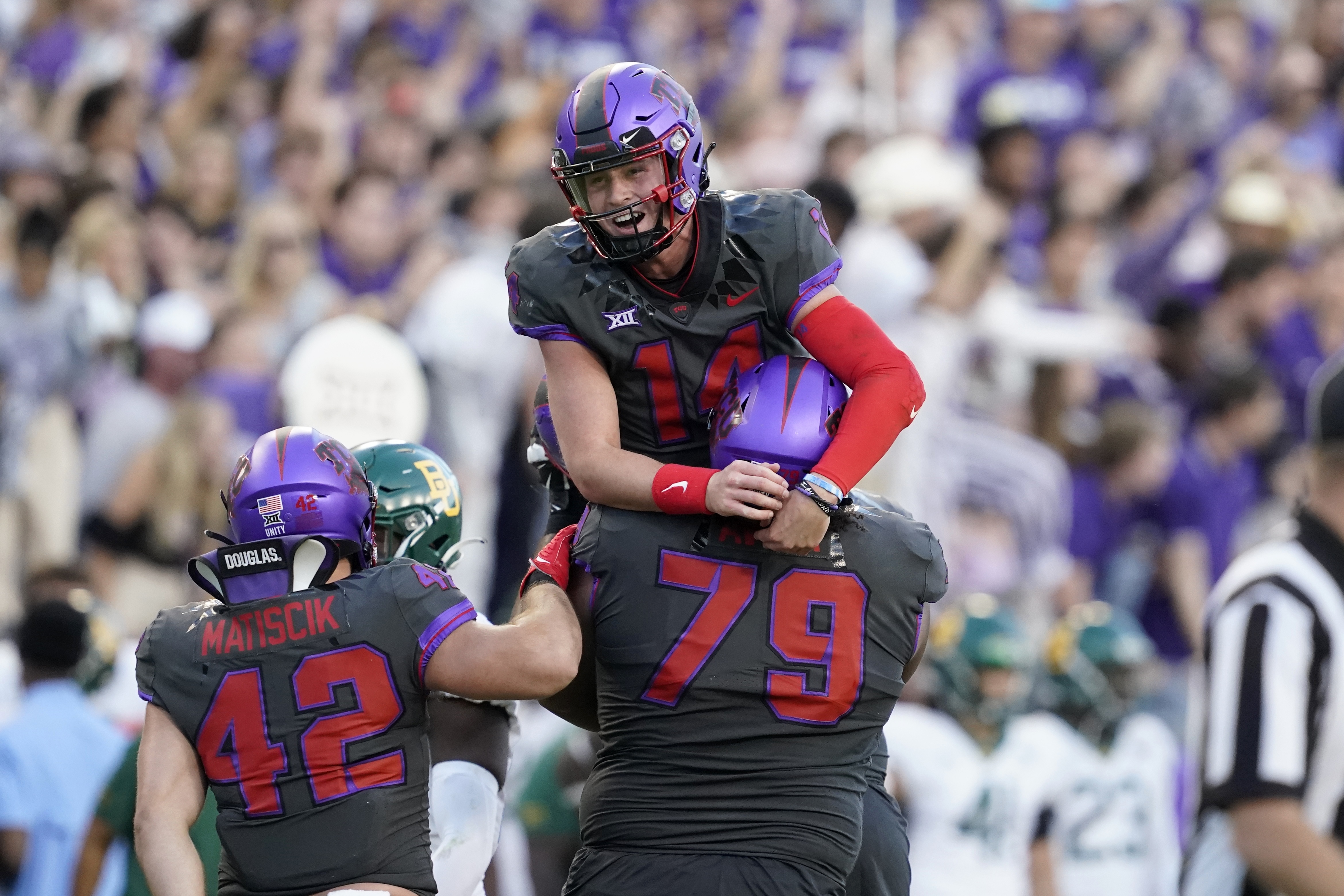 Baylor running back Trestan Ebner (1) leaps over TCU placekicker