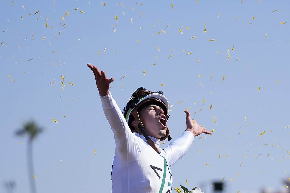 Irad Ortiz Jr. celebrates after riding Life is Good to victory during the Breeders' Cup Dirt Mile race at the Del Mar racetrack in Del Mar, Calif., Saturday, Nov. 6, 2021. (AP Photo/Jae C. Hong)