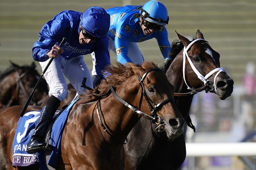 William Buick, left, rides Space Blues to victory past Umberto Rispoli, riding Smooth Like Strait, during the Breeders' Cup Mile race at the Del Mar racetrack in Del Mar, Calif., Saturday, Nov. 6, 2021. (AP Photo/Jae C. Hong)