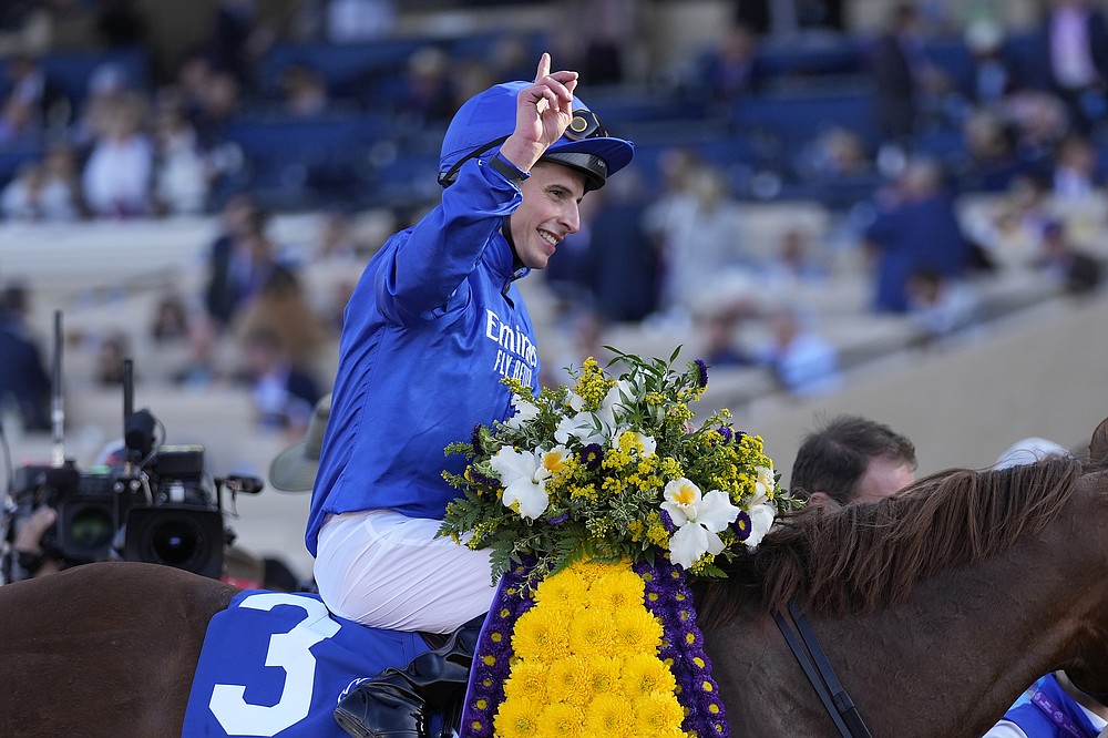 William Buick celebrates after riding Space Blues to victory during the Breeders' Cup Mile race at the Del Mar racetrack in Del Mar, Calif., Saturday, Nov. 6, 2021. (AP Photo/Jae C. Hong)