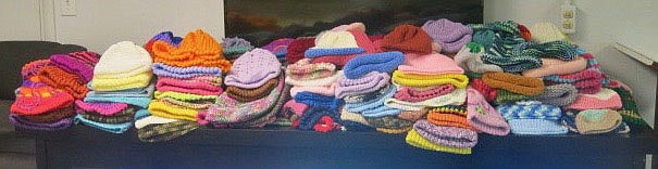 Westside Eagle Observer/SUSAN HOLLAND
A tableful of hats in several sizes and a wide variety of colors shows the result of several hours of work by ladies who have been knitting and crocheting hats for patients at Arkansas Childrens Hospital. Dr. Nancy Jones started the project as an activity for her Girl Scout troop and it has expanded to become a part of the "Knitting for Noggins" project at ACH with several women contributing their time and talents to create hats.