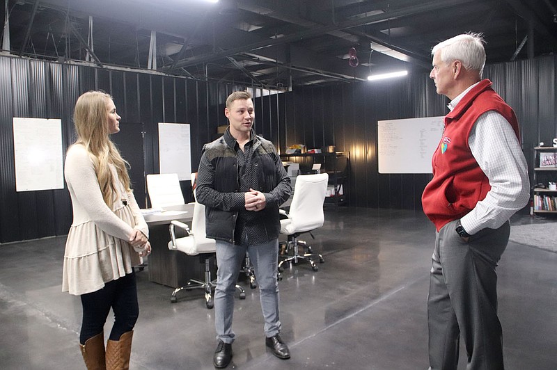 LYNN KUTTER ENTERPRISE-LEADER U.S. Rep. Steve Womack of Arkansas tours Savage Savage, a new company in Lincoln that focuses on health, nutrition and fitness. Owners Robert and Crystal Sikes visit with Womack during the tour, held Tuesday, Nov. 9. They are standing in the conference room where everyone gathers each morning before going separate ways to work on different aspects of the company, which include podcasts and videos, producing keto nutrition bars, creating apparel and workouts in the training room.