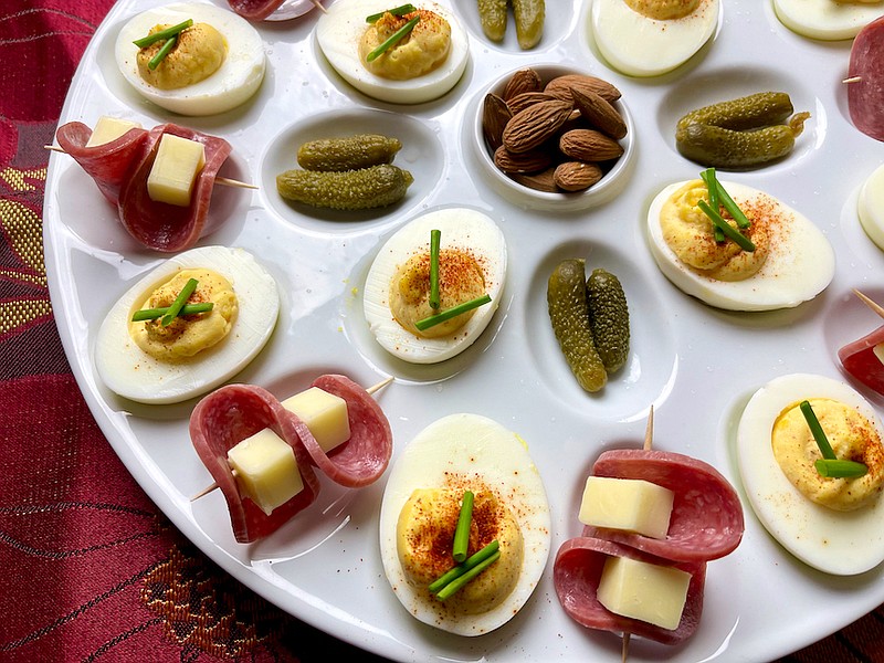 Deviled eggs alongside cornichons (tiny sour pickles), almonds and salami-wrapped cheese make an easy, yet festive finger food spread. (Arkansas Democrat-Gazette/Kelly Brant)