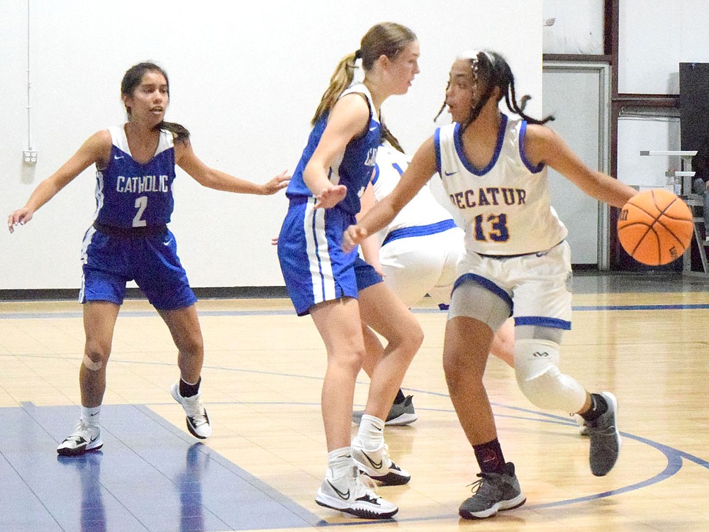 Westside Eagle Observer/MIKE ECKELS
Lady Bulldog Naomi Jimenez (13) makes her move towards the basket as she skirts past two Lady Griffin players during the second quarter of the Decatur-Ozark Catholic varsity girls basketball contest in Bentonville Nov. 9. Jimenez' made her shot for two points but it was not enough to stave off the Lady Griffins 27 point win.