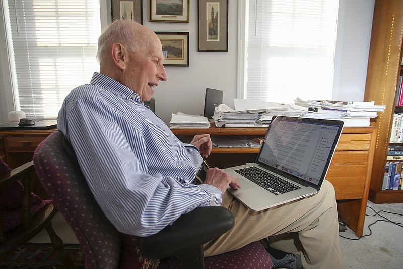 Manfred Steiner, who earned his Ph.D. in physics from Brown University at the age of 89, displays his doctorate thesis on his laptop at his home in East Providence, R.I., Wednesday, Nov. 10, 2021. After retiring from his career in medicine in 2000, Steiner pursued his dream of earning a doctorate in physics. (AP Photo/Stew Milne)