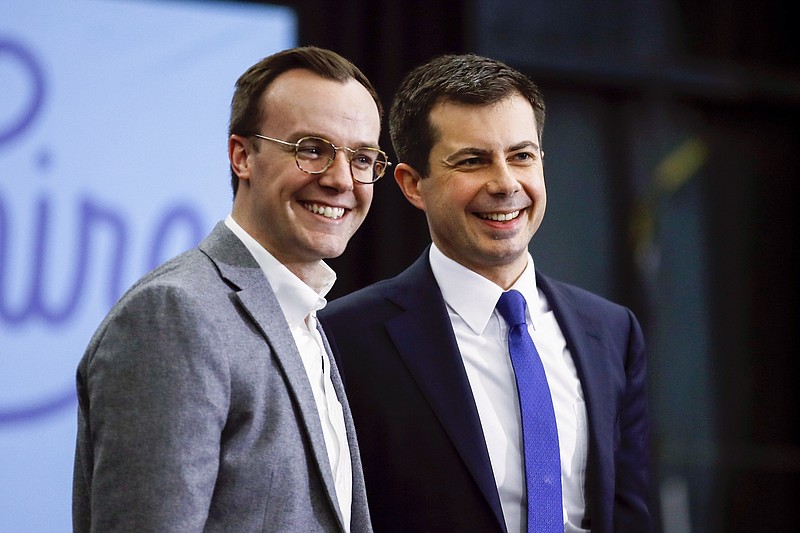 Chasten (left) and Pete Buttigieg smile to the crowd at a 2020 campaign event. The couple, and their unique situation, are profiled in “Mayor Pete,” now streaming on Amazon Prime. (AP file/Matt Rourke)