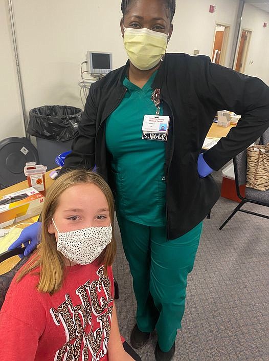 Contributed photo
Shakela Mitchell administers the COVID-19 vaccination to Anna Yarbro, age 11, at the Green Center at OCMC.