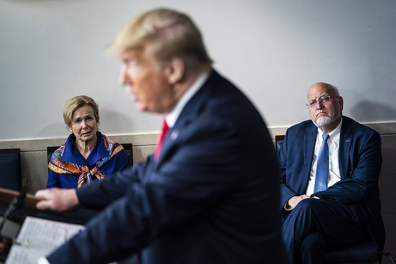 In this April 2020 photo, Dr. Deborah Birx, White House coronavirus response coordinator, and Dr. Robert Redfield, director of the Centers for Disease Control and Prevention, listen as President Donald Trump speaks during a briefing in response to the coronavirus pandemic. MUST CREDIT: Washington Post photo by Jabin Botsford.