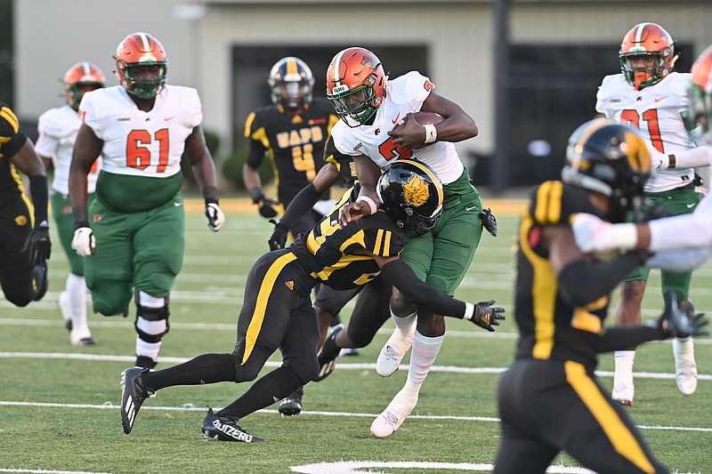 Florida A&M backup quarterback Cameron Sapp carries the ball as he is tackled by UAPB defensive back Kaleb Knox in the second half Saturday. (Special to The Commercial/Darlena Roberts)