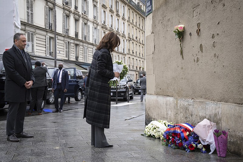 Vice President Kamala Harris lays flowers to honor the victims of the attack on Paris at the Carillon Caf&#xe9; in Paris, France, Saturday, Nov. 13, 2021. On Nov. 13, 2015, a series of coordinated terrorist attacks occurred through Paris killing a total of 130 people, 13 at Le Carillon and Le Petit Cambodge cafes. (Sarahbeth Maney/The New York Times via AP, Pool)