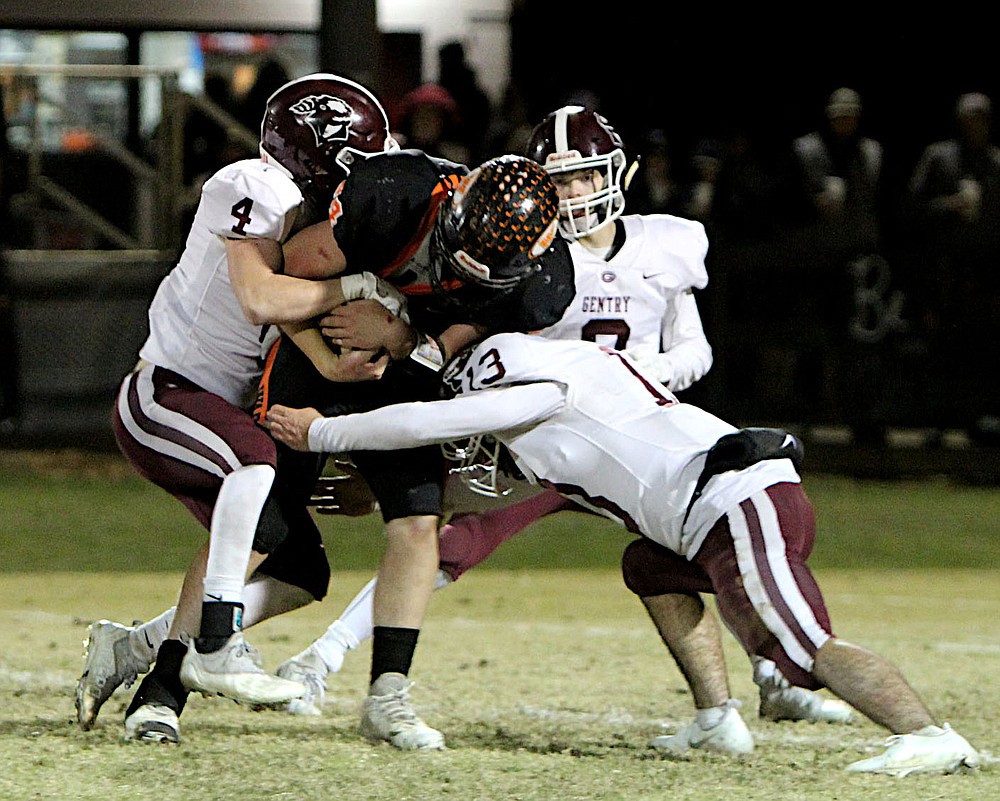 Submitted/NIKKI SLONE RAYBURN-STILL
Gentry seniors Dawson Rayburn and Bryson Walker put an end to a Lamar running play during Friday's playoff game at Lamar High School.
