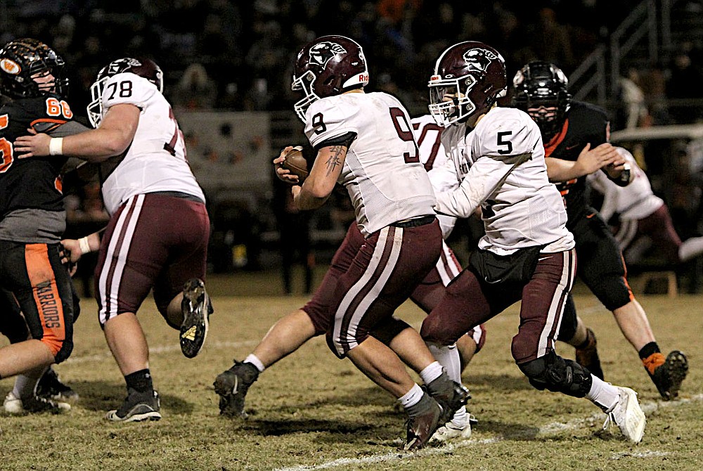 Submitted/NIKKI SLONE RAYBURN-STILL
Gentry senior Zach Gunneman takes a handoff from junior quarterback Chris Bell during Friday's playoff game at Lamar High School.