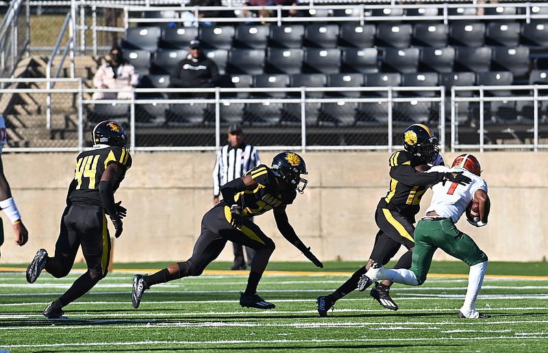 UAPB defensive back Nathan Seward tackles Florida A&M running back Bishop Bonnett in the open field Saturday at Simmons Bank Field at Golden Lion Stadium. (Special to The Commercial/Darlena Roberts)
