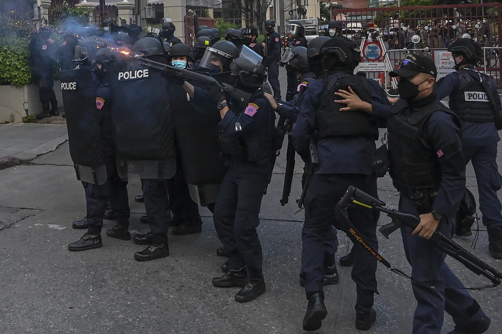 Riot police launch rubber bullet to disperse anti-government protesters during a protest Bangkok, Thailand, Sunday, Nov. 14, 2020. Protesters calling for the reform of the monarchy returned to the streets of Bangkok despite the ruling of the Constitutional Court on Wednesday that such demands are tantamount to attempting to overthrow the system of government with the king as head of state. (AP Photo/Surat Sappakun)