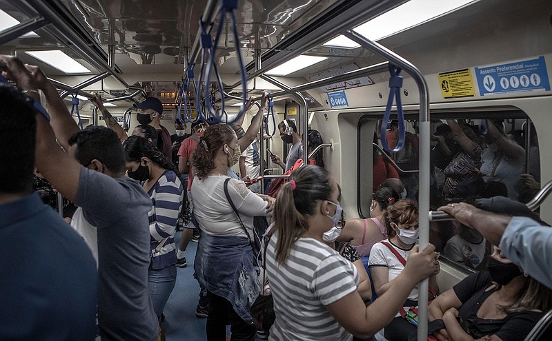 Commuters wearing protective masks stand in a train car in Sao Paulo, Brazil, on Oct. 8, 2020. (Bloomberg/Jonne Roriz)