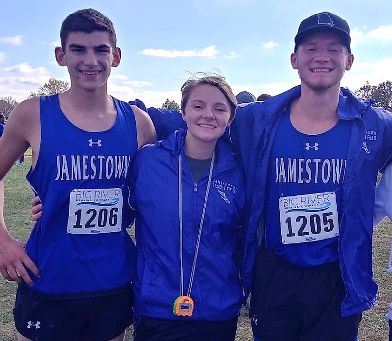 Submitted
Junior James Scheperle (left), head coach Makayla Howard (middle) and junior Carter Monroe (right) at their district meet in Linn. Scheperle finished in 63rd with a time of 22:24. Monroe qualified for state after finishing 13th with a time of 19:06, bringing Jamestown's cross country program to the highest level of competition in just its first season.