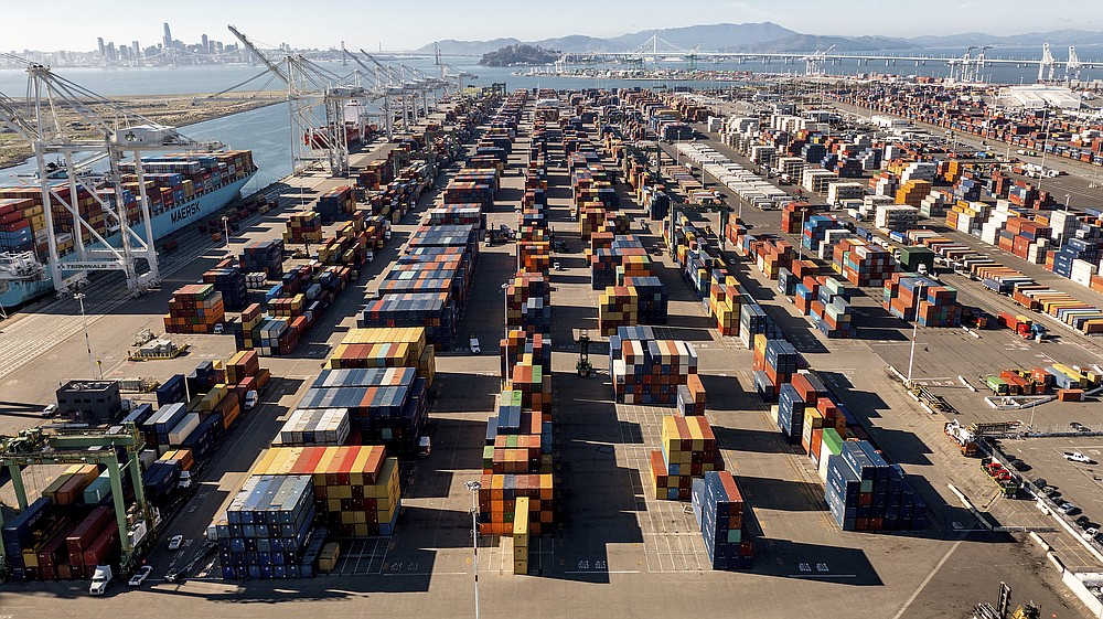 Containers line a Port of Oakland shipping terminal on Wednesday, Nov. 10, 2021, in Oakland, Calif. Intense demand for products has led to a backlog of container ships outside the nation's two largest ports along the Southern California coast. (AP Photo/Noah Berger)