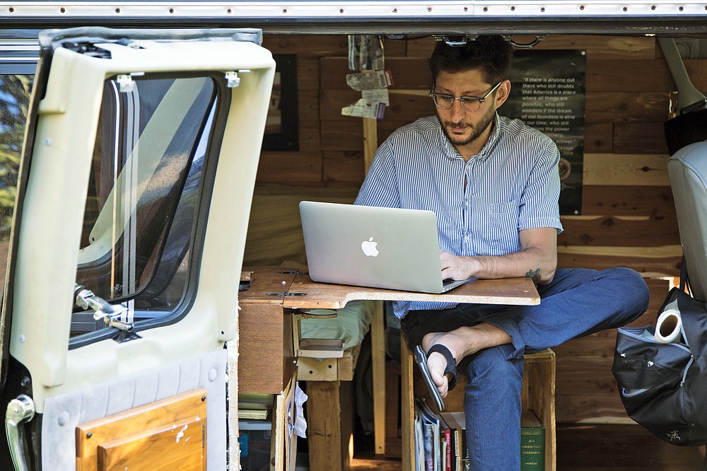 FILE - U.S. journalist Danny Fenster works out of his van that he made into a home/office in Detroit in 2018. Former U.S. Ambassador to the U.N. Bill Richardson said Monday, Nov. 15, 2021, American journalist Fenster has been released from prison in Myanmar.(Fenster Family photo via AP, File)